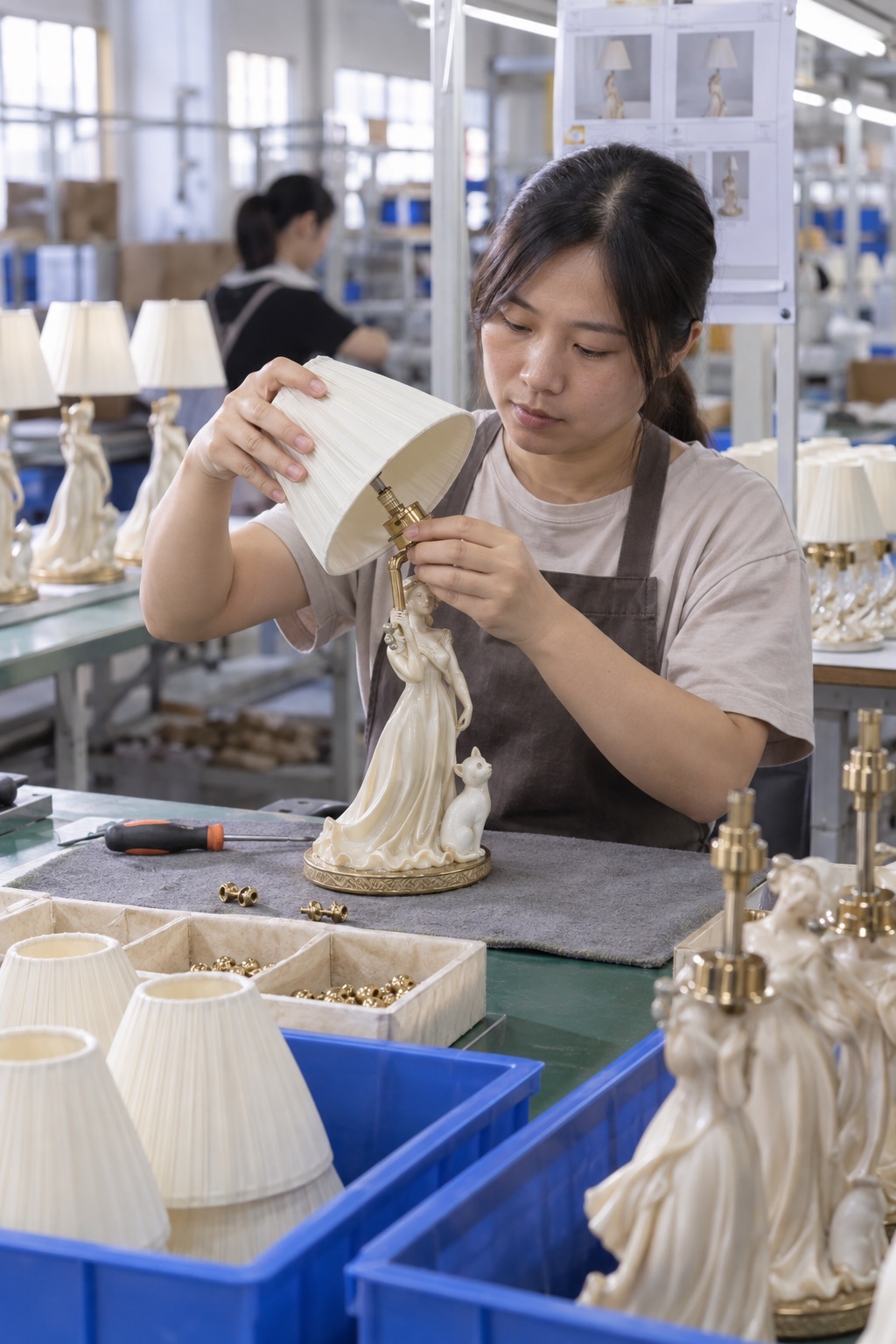 Craft worker fitting lamp hardware and components during decorative product assembly
