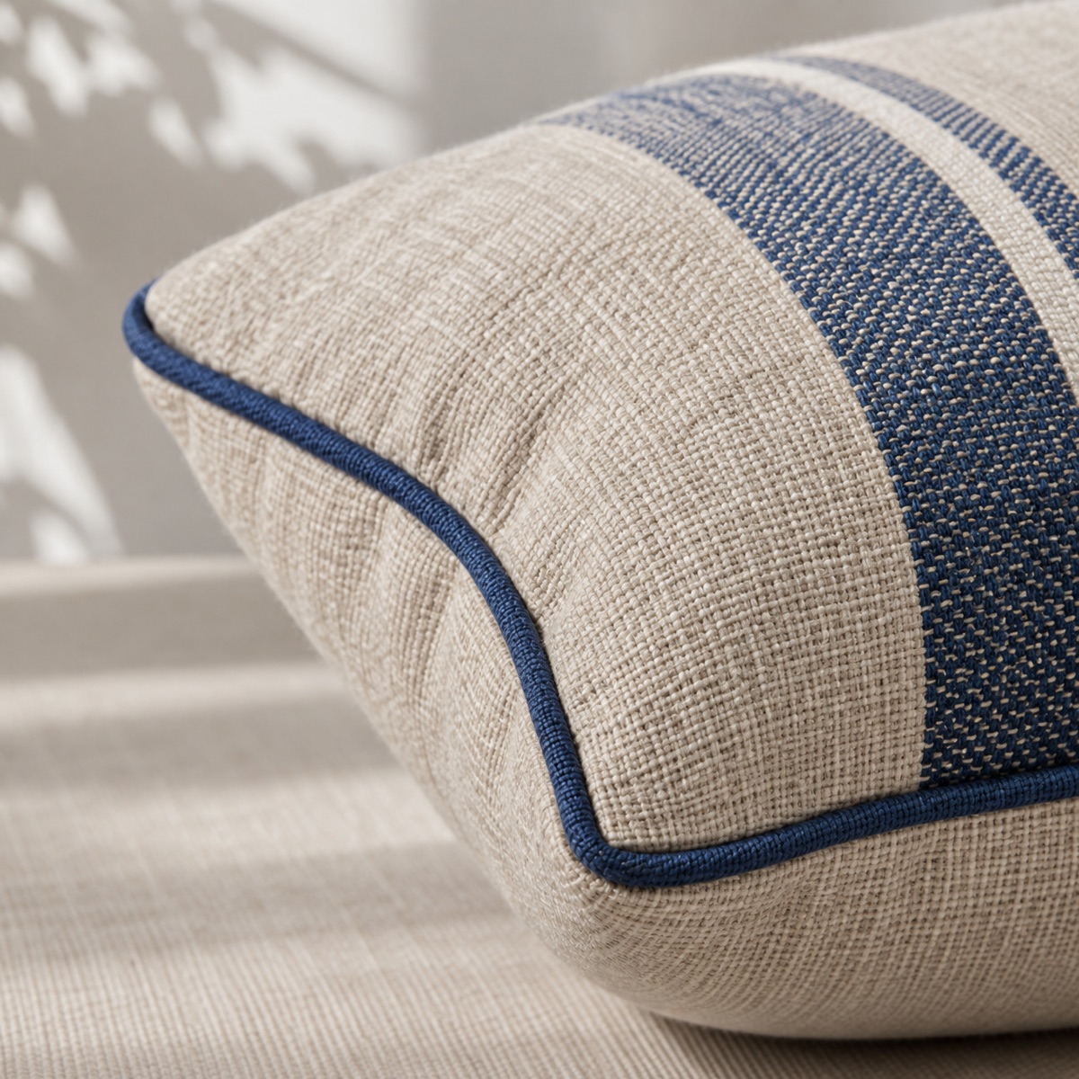 Woven textile accessory with piping and stitched seams